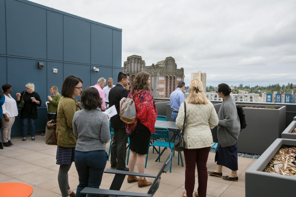 Photo of attendees of the ground breaking ceremony gathered on the roof deck at Arbora Court