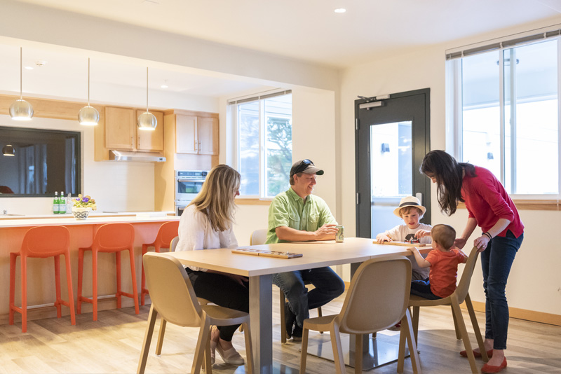 Photo of family gathering in Arbora Court community room