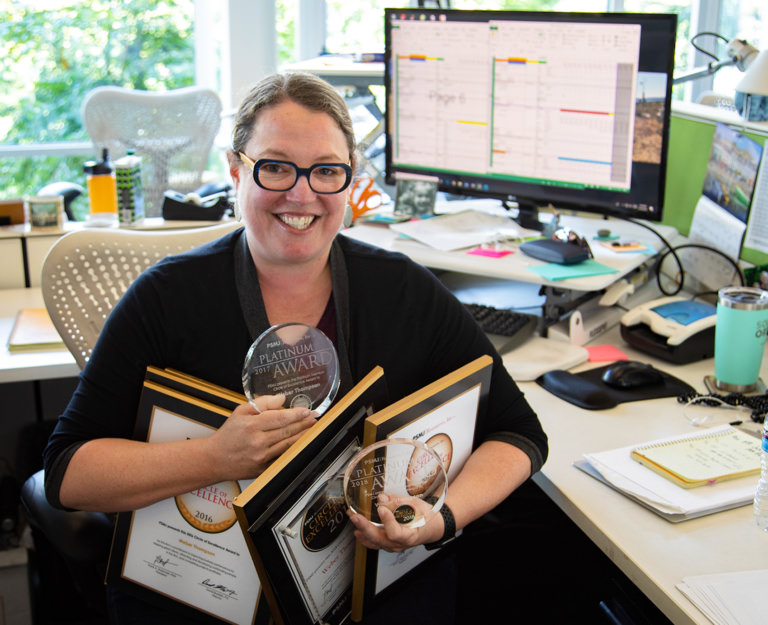 Photo of Elizabeth Holland holding Weber Thompson PSMJ Awards