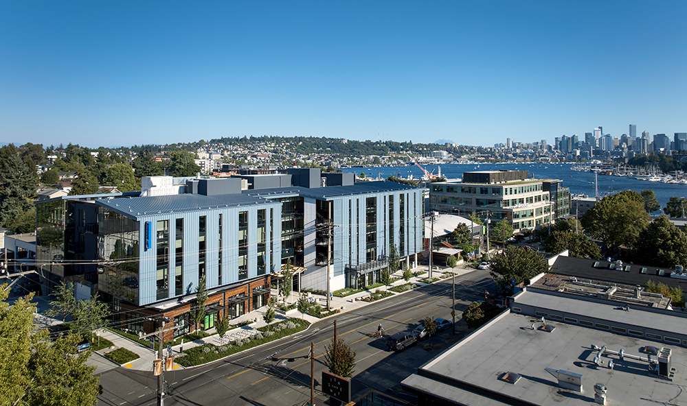 drone photo of 35 stone on a sunny day with lake union and downtown seattle in the background