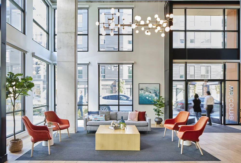 Photo of the interior lobby with a statement piece chandelier at Trailside Student Housing