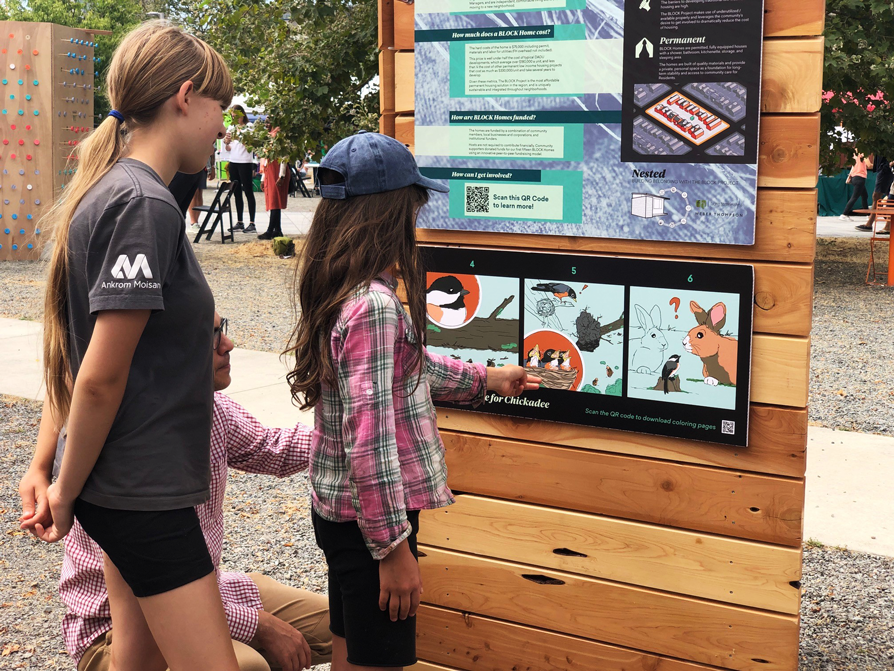 Photo of kids looking at the illustrated comic.