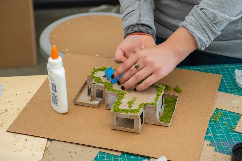 Close up photo of a student's hands creating a model 