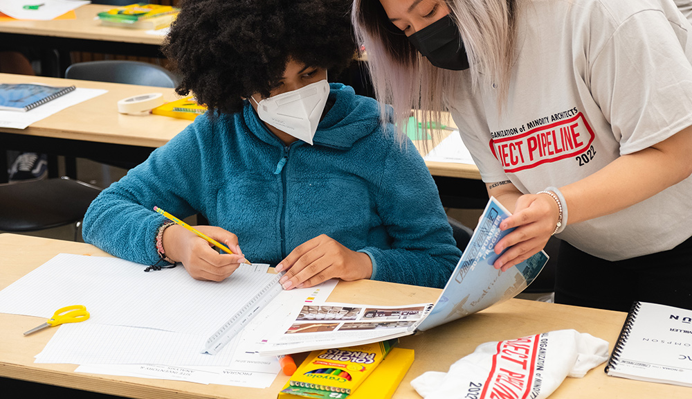 Photo of students designing their models