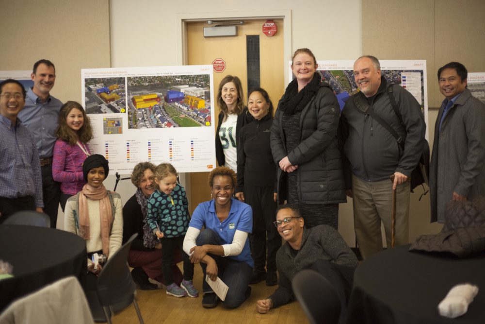 Group photo of Jeff Reibman working with Othello Square community members