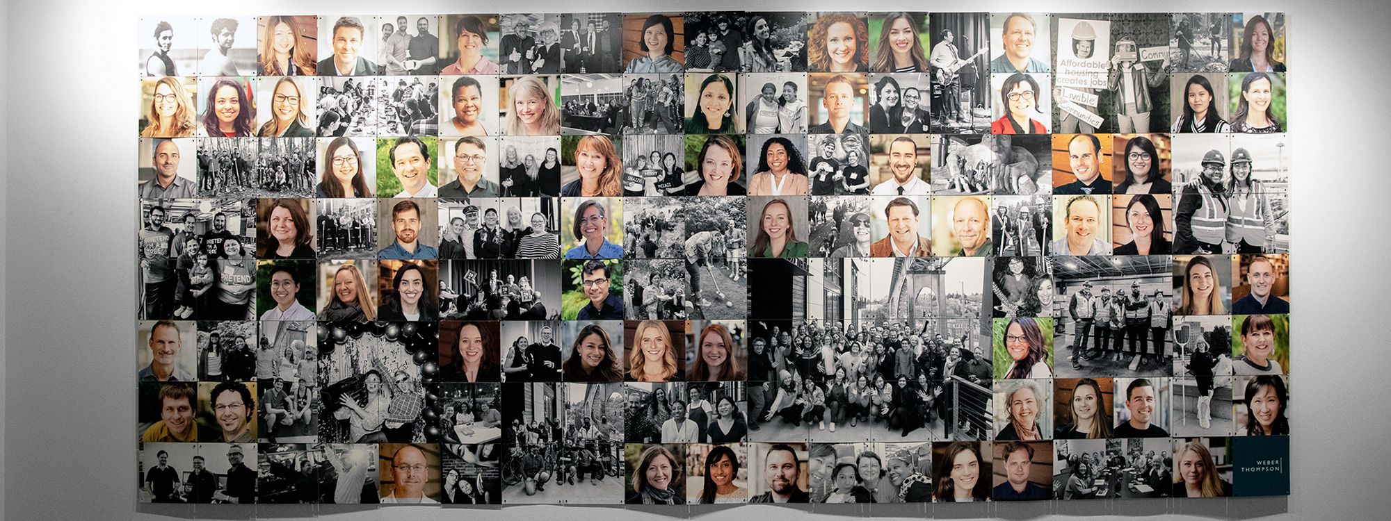 Photo of Weber Thompson employees on the wall in the office