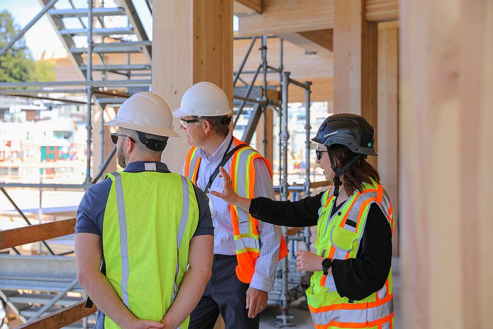 Photo of a weber thompson team member taking clients on a tour of a mass timber project
