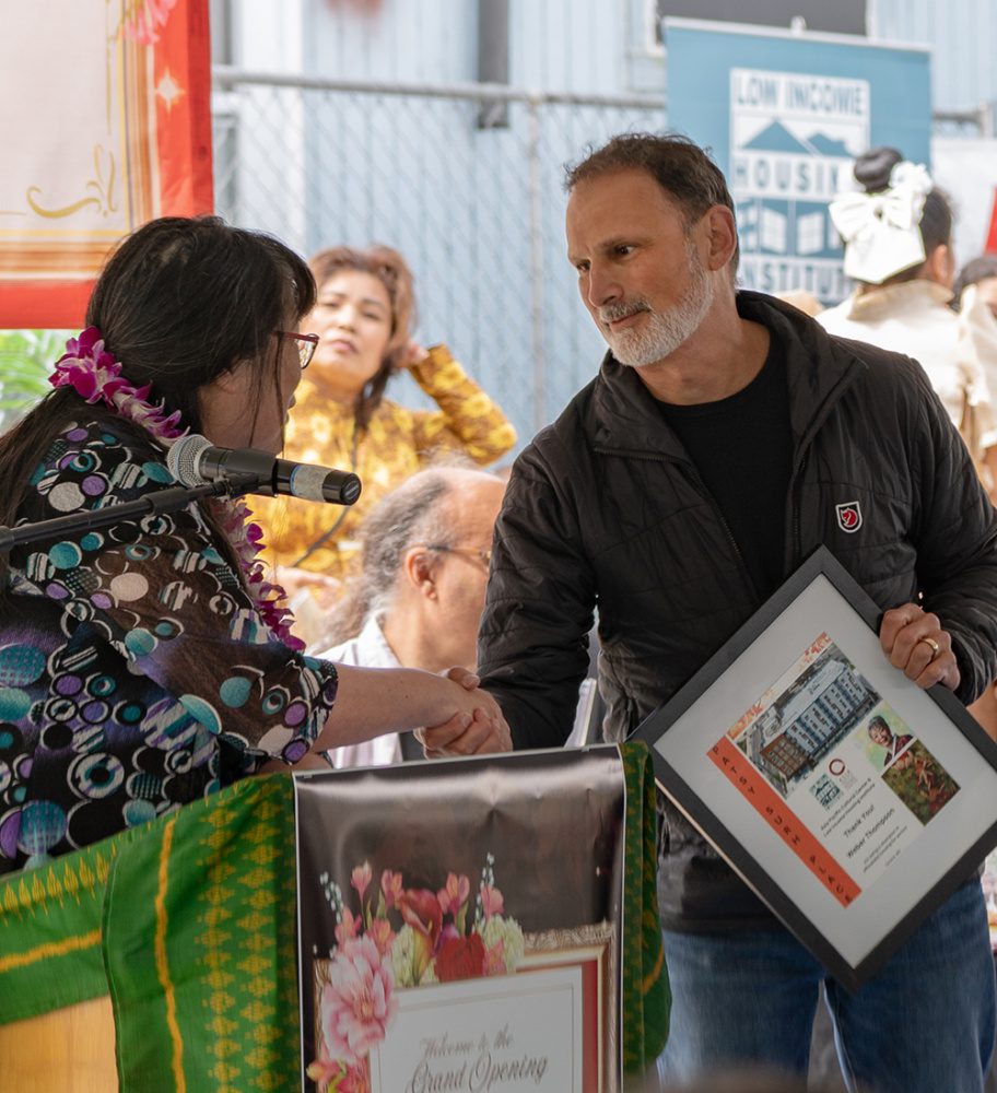 photo of jeff reibman shaking hands with a client at a grand opening ceremony