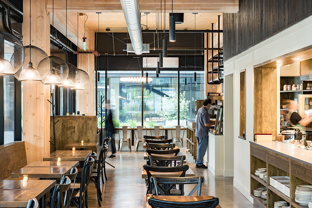 photo of the interior of the wayland mill with warm wood accents surrounded by mass timber columns and warm lighting