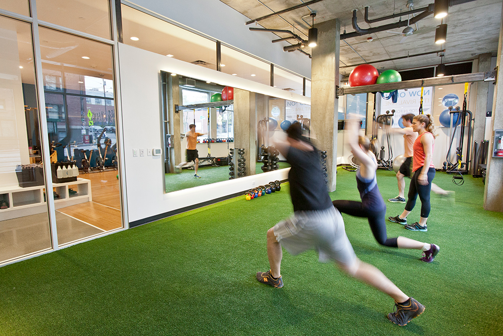 photo of the tenant improvement at rival fitness featuring people working out on turf