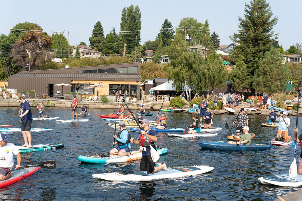 photo of paddlers entering the water at the clean lake union paddle race at gasworks brewing