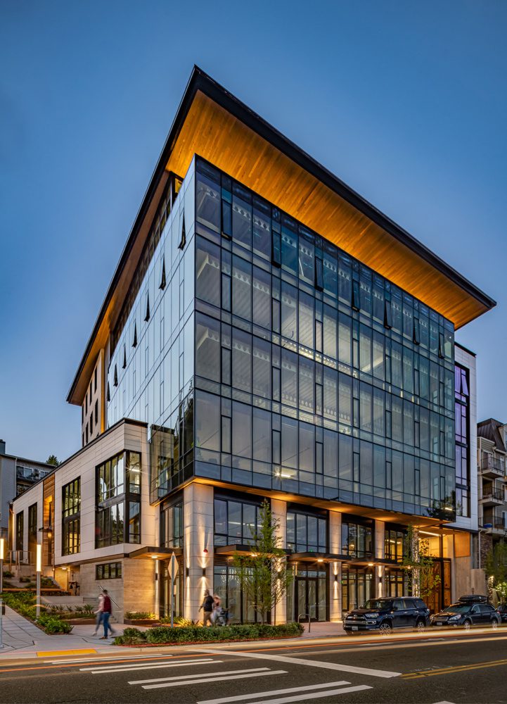 photo of watershed building at dusk with the sidewalk activated and cars on the street