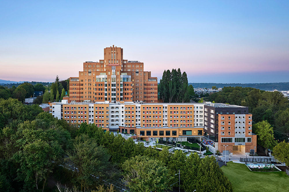 photo of beacon pacific village at dusk with mount rainier in the background
