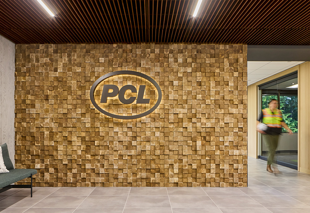 photo of the end cut timber wall with PCL logo lit up