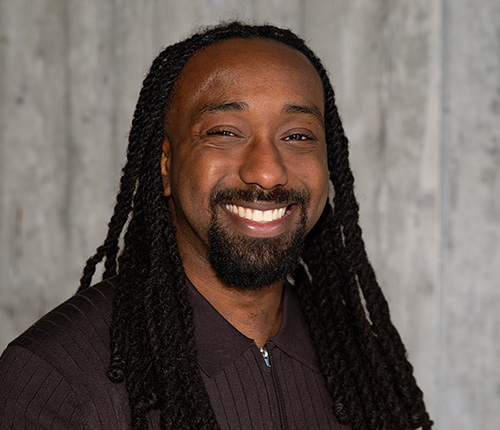 Portrait of Isaiah Lee against a grey backdrop