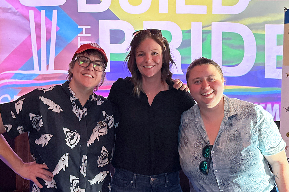 photo of weber thompson employees at build with pride seattle event with pride flag in background