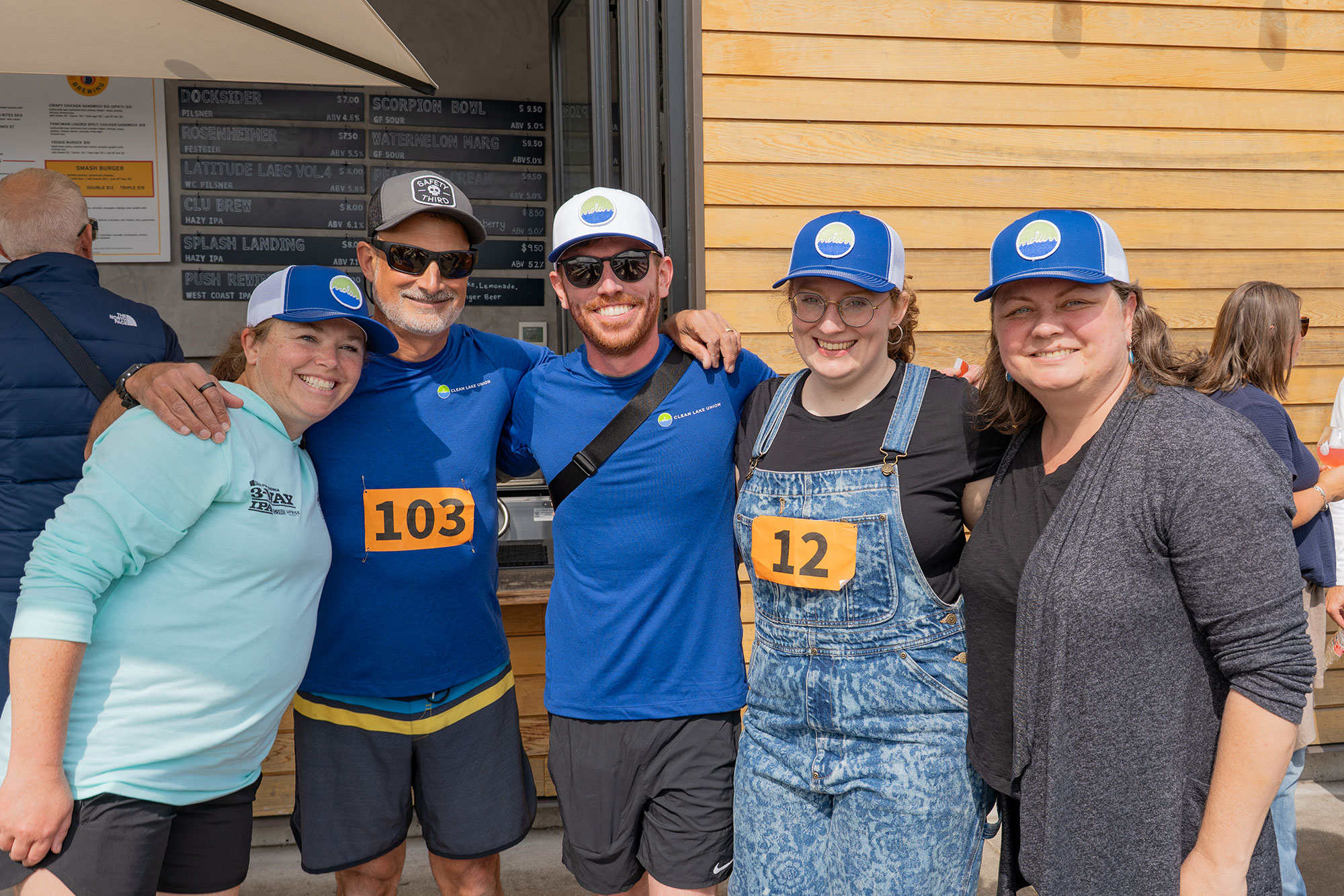 group photo of weber thompson employees standing together at an event on a sunny day